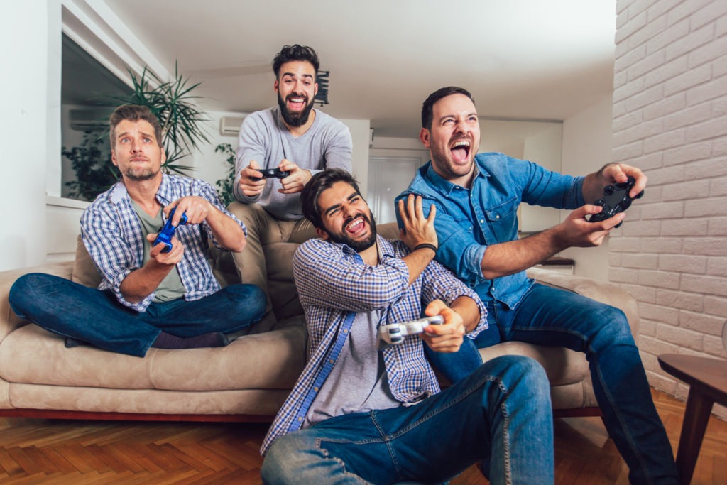 man playing video games with his friends