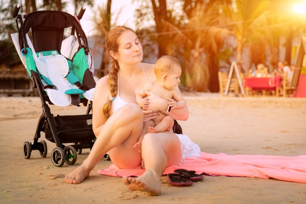 mother and baby with beach stroller
