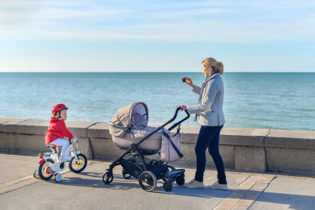 mother and daughter with beach stroller