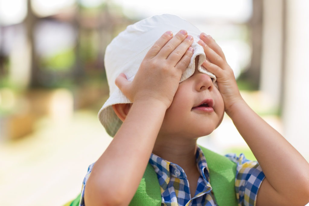 Playful Little Boy Covering Eyes With Hands