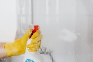 spraying-a-glass-cleaner