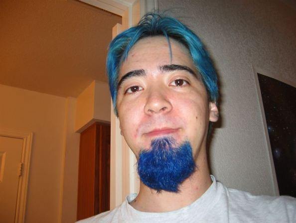 A-man-covering-his-hair-in-blue-color-completely.