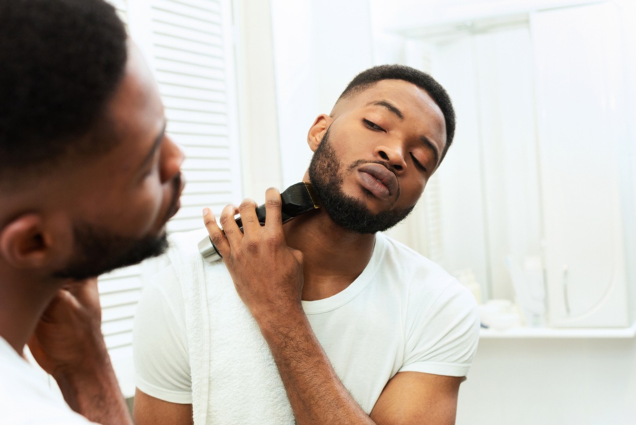 A man trims his beard