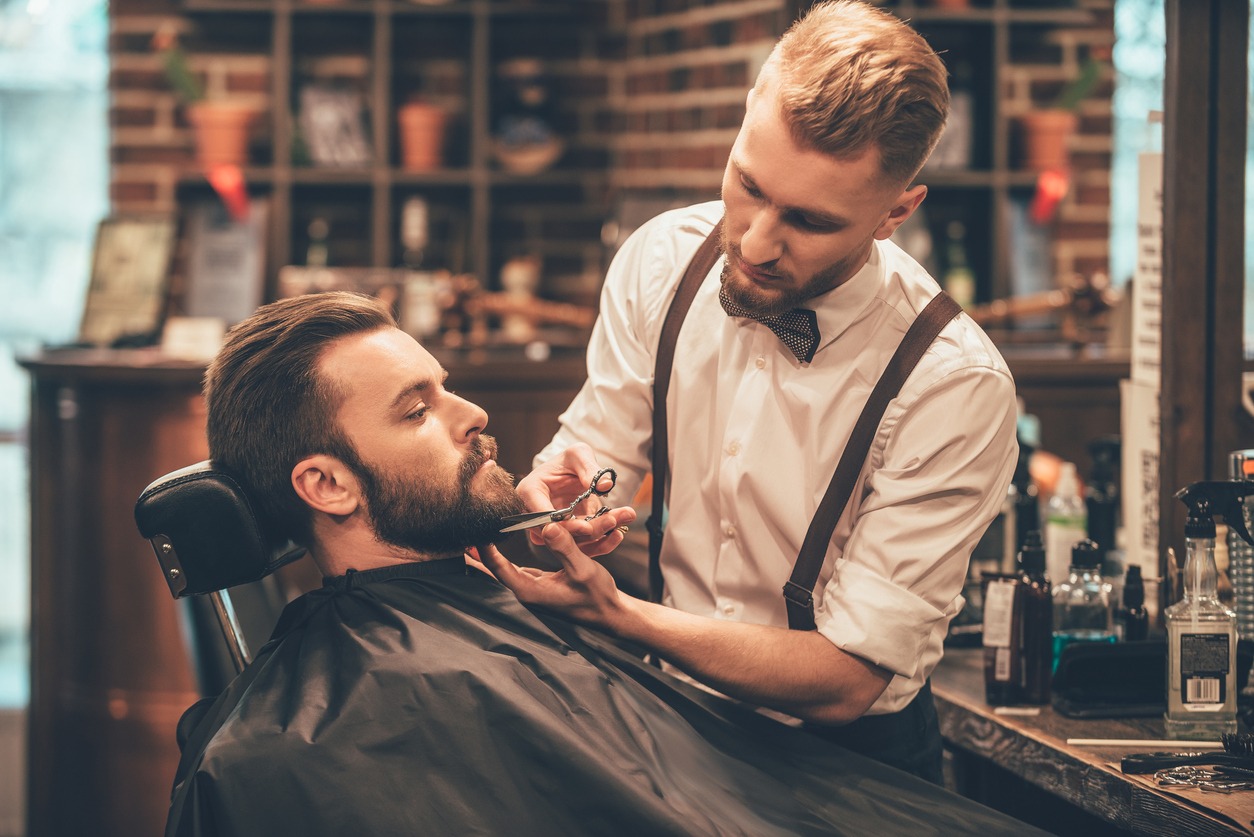 A man’s beard being groomed