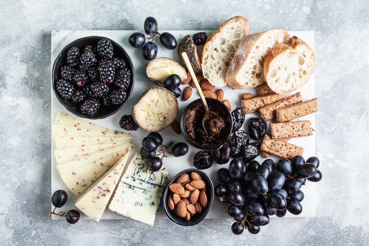 A-marble-cheese-board-with-cheeses-berries-nuts-and-bread