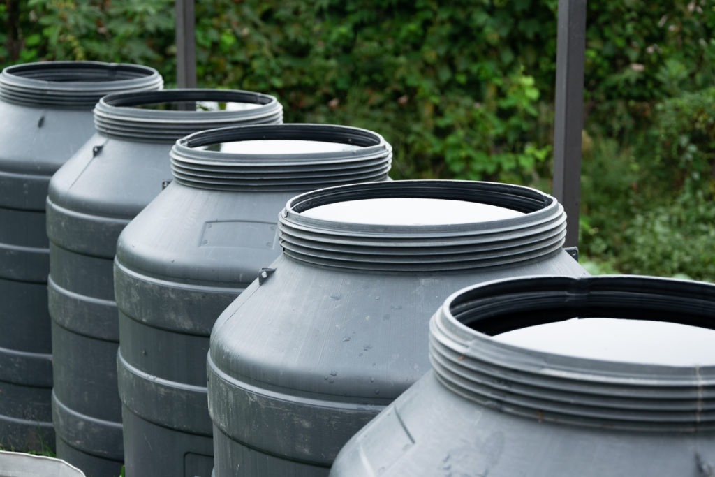 A row of large rainwater barrels