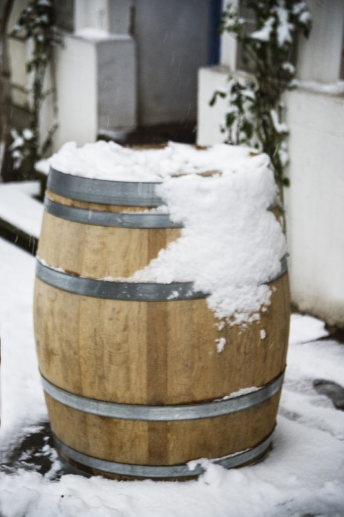 A water barrel with snow in it