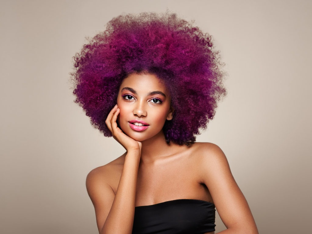 A woman with a purple dyed afro 