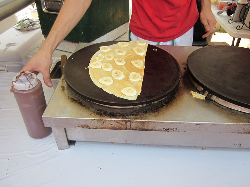 Banana nutella crepe being prepared by food vendor