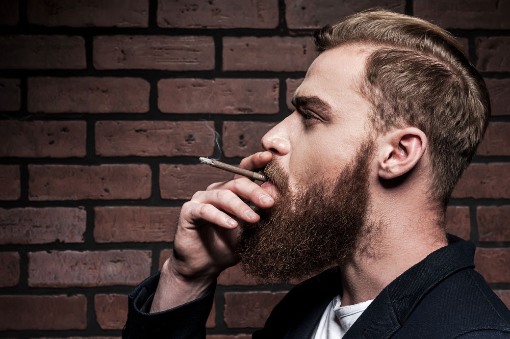 Bearded-man-smoking-brown-cigarillo