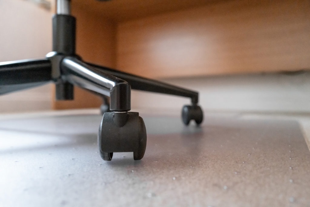 Carpet level view of a typical office chair legs and castors