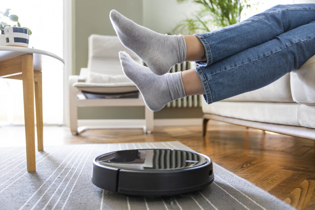 Robotic vacuum cleaner cleaning a living room.