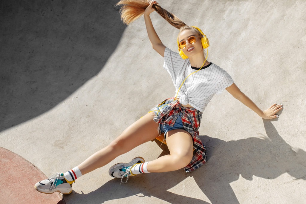 Teenage girl riding a skateboard wearing sneakers and stylish socks