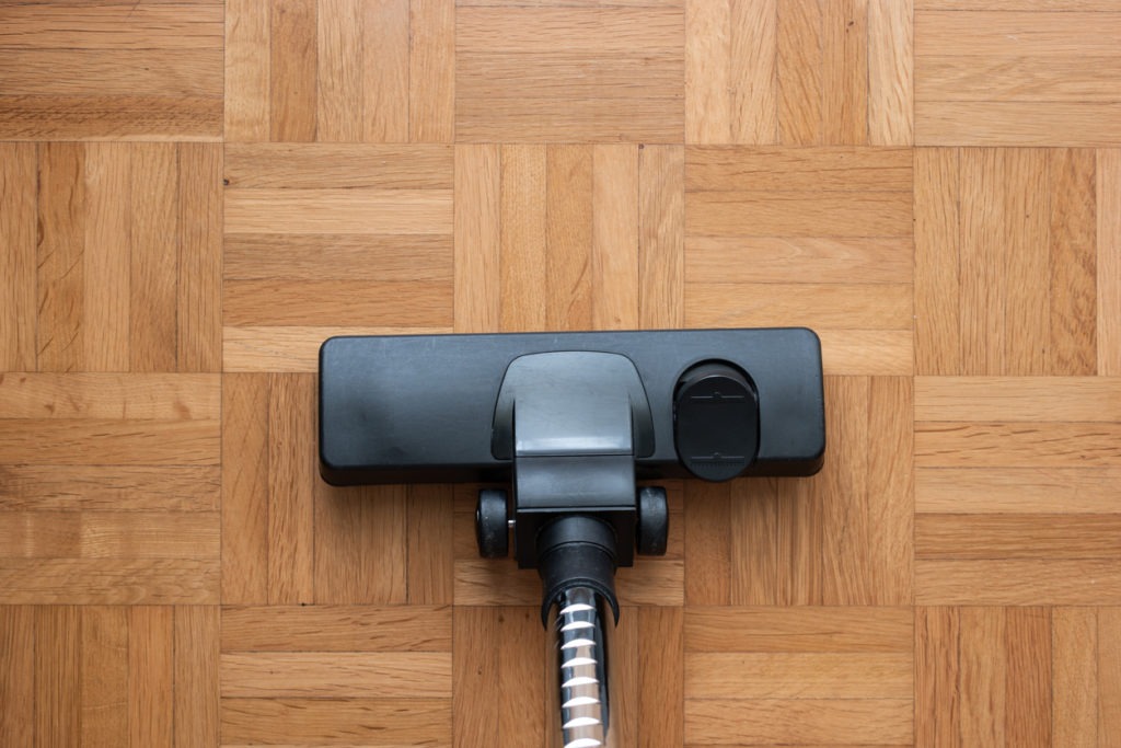 Vacuum attachment on a wooden floor.