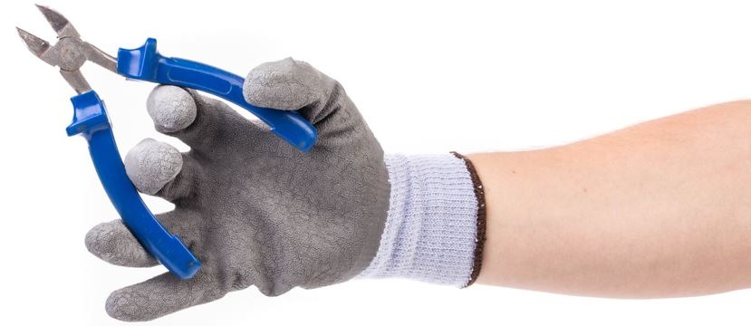 a person holding wire cutters and wearing a glove