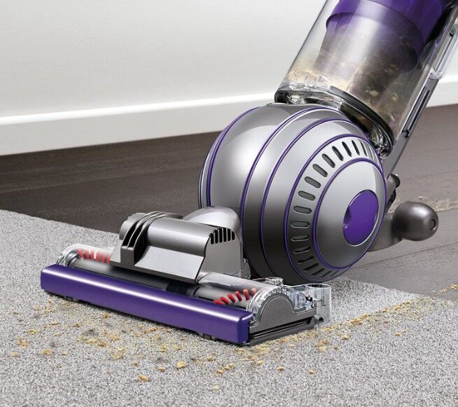 cleaning-a-carpet-using-a-Dyson-vacuum-cleaner