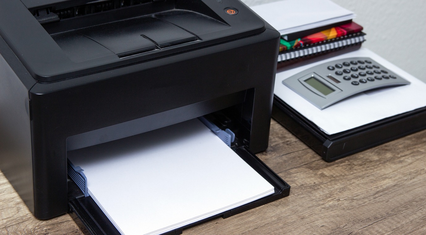 Laser printer and office supplies on the table
