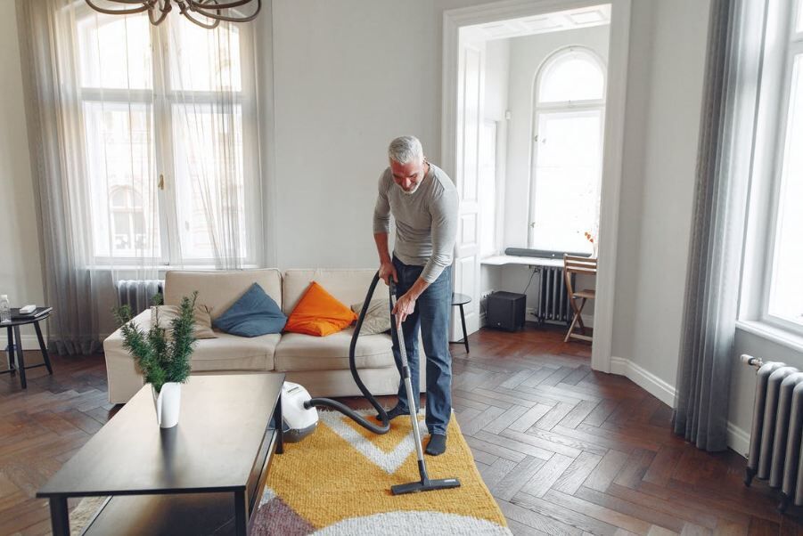 man-vacuuming-carpet