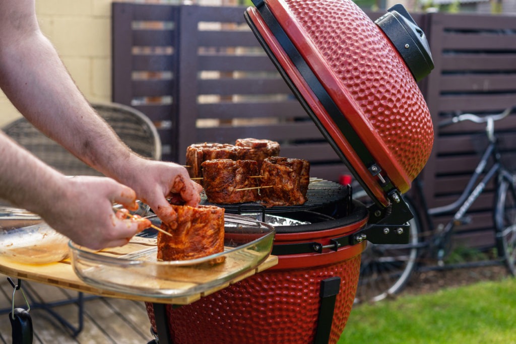 Red Ceramic Barbecue Grill. Grilling, Smoking, Baking, BBQ and Roasting process