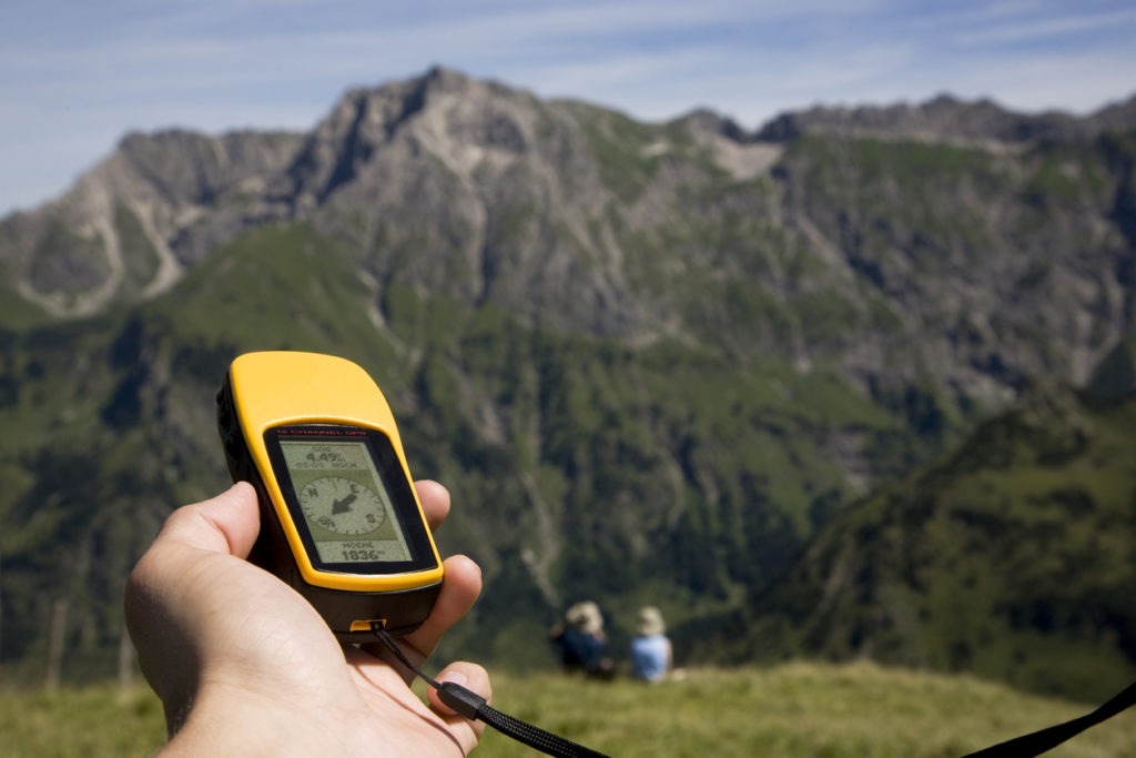 sharp GPS and two unsharp people in the alps