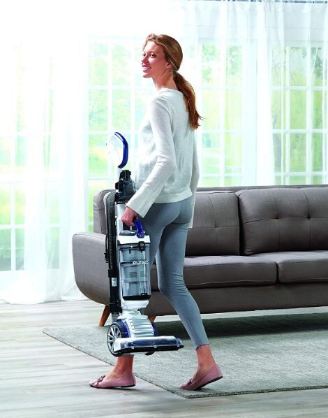 woman-carrying-a-Eureka-upright-vacuum-cleaner