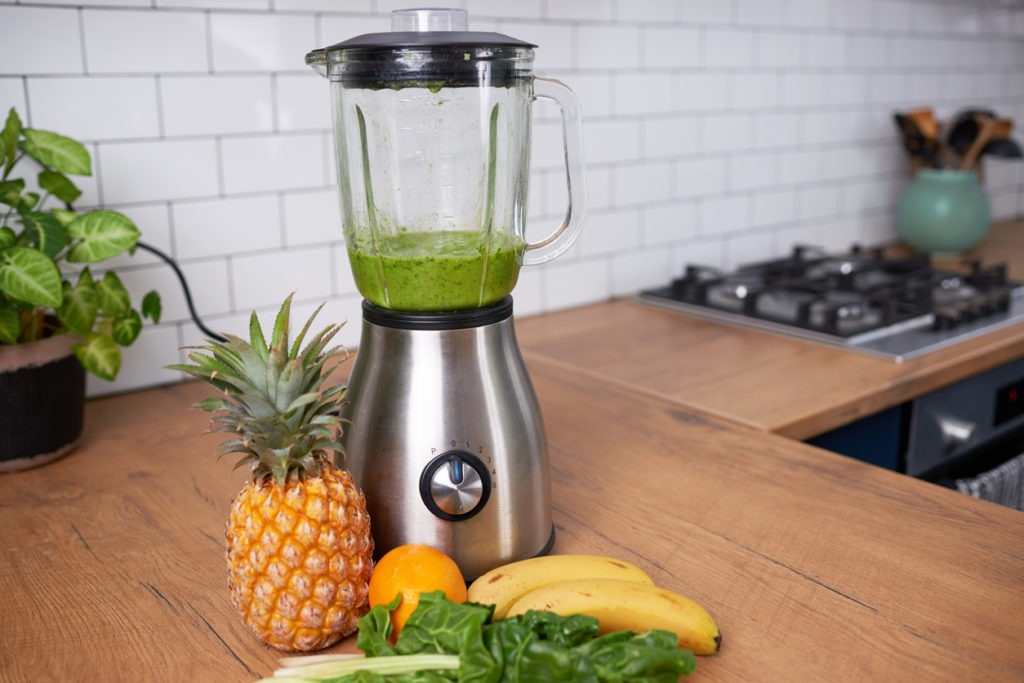 a countertop blender along with fresh fruits