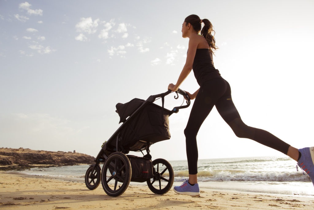 a mother jogging with her child in a stroller