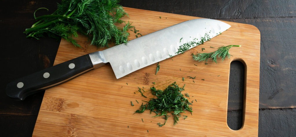 a santoku knife on a chopping board