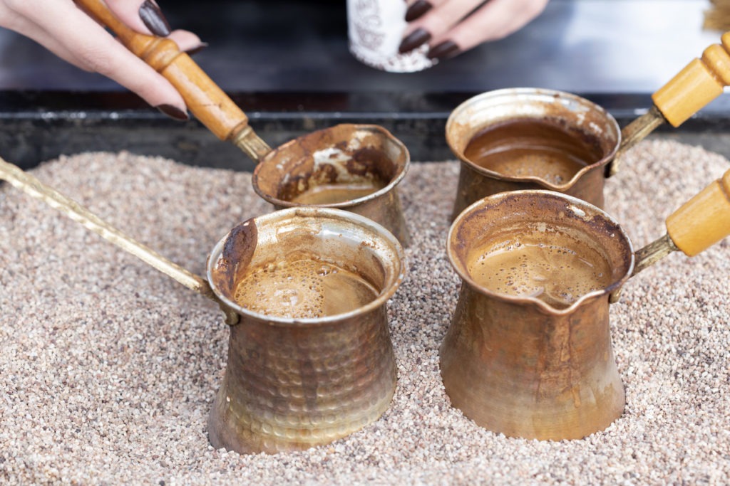 brewing coffee using Turkish coffee pots