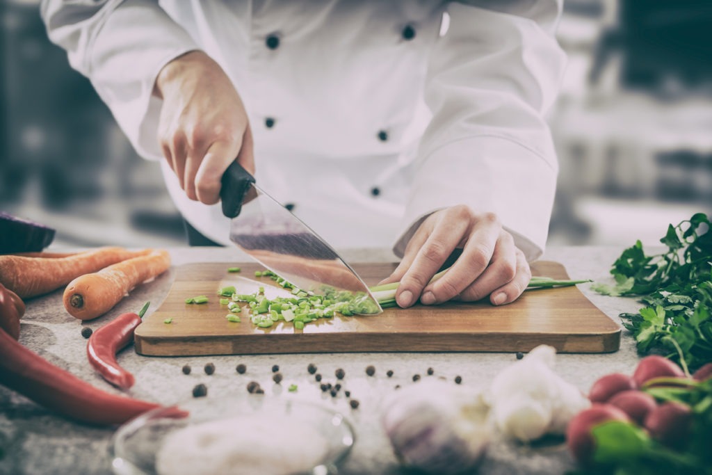 chopping veggies using a chefs knife