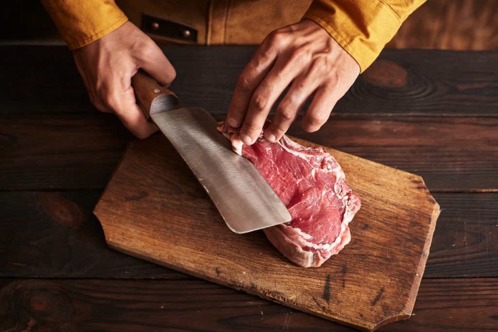 cutting meat using a cleaver