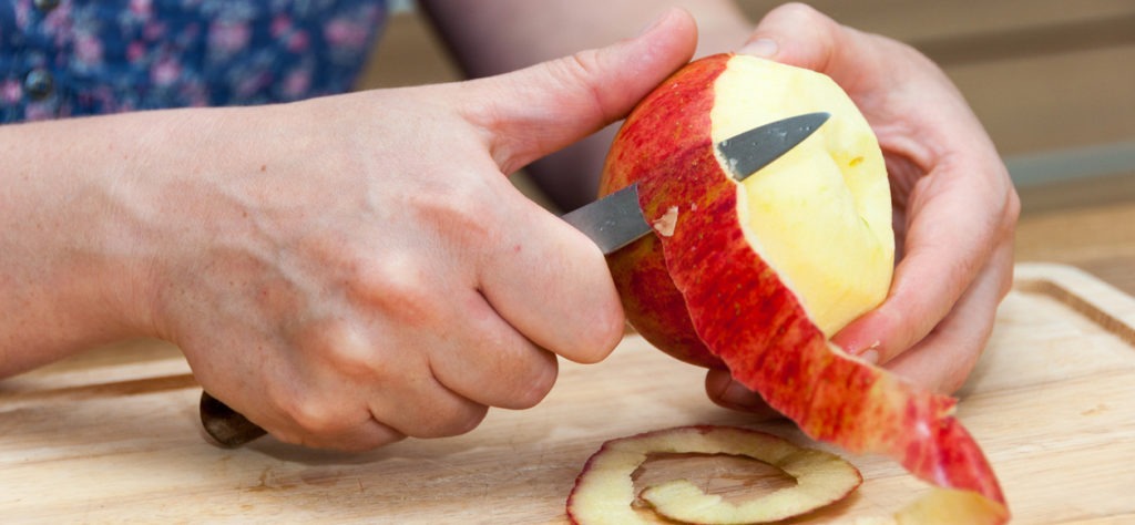person peeling an apple