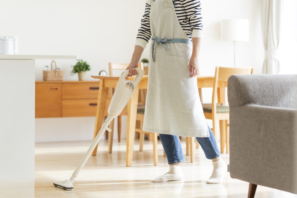person using a cordless vacuum cleaner