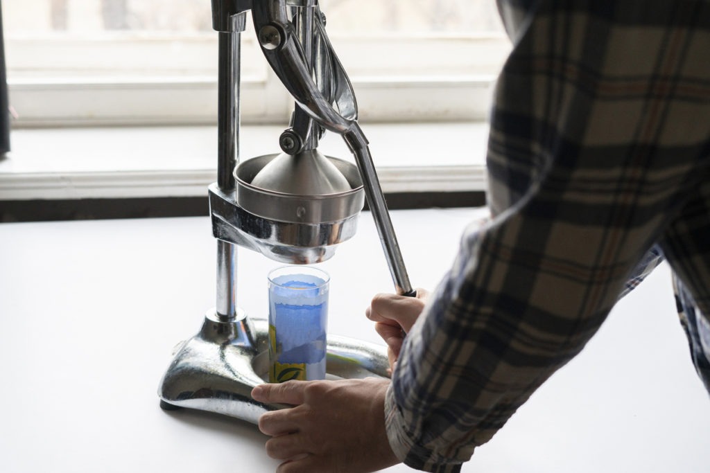 person using a juice press