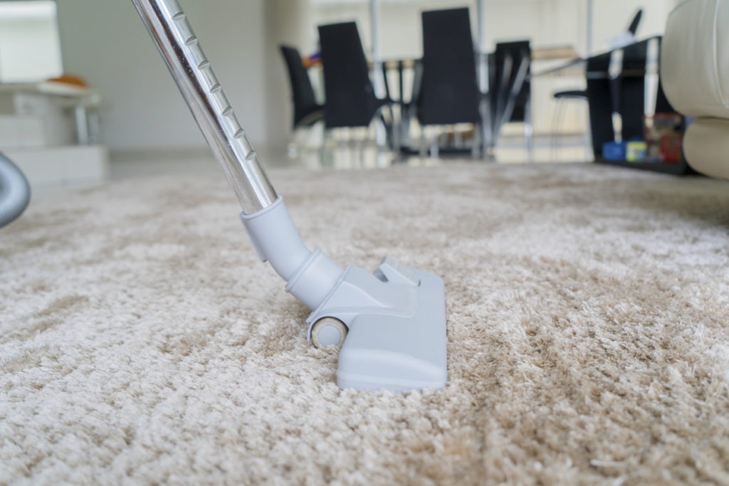 vacuuming carpeted flooring