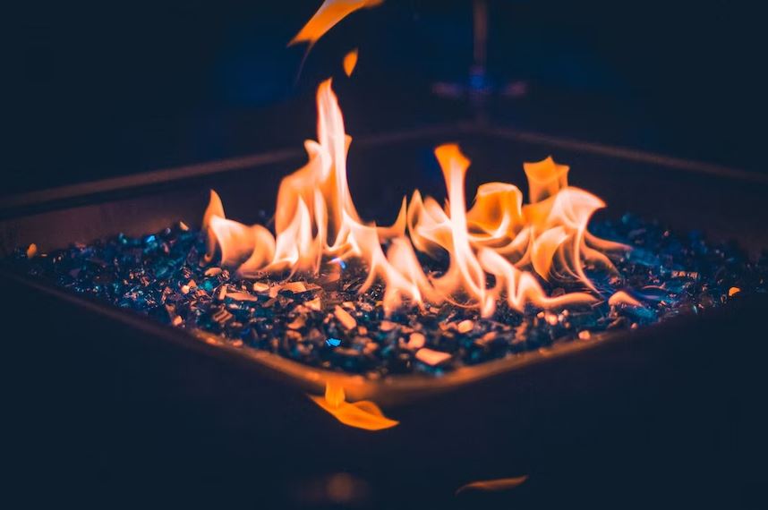 A close up shot of a charcoal fire pit with an active fire.