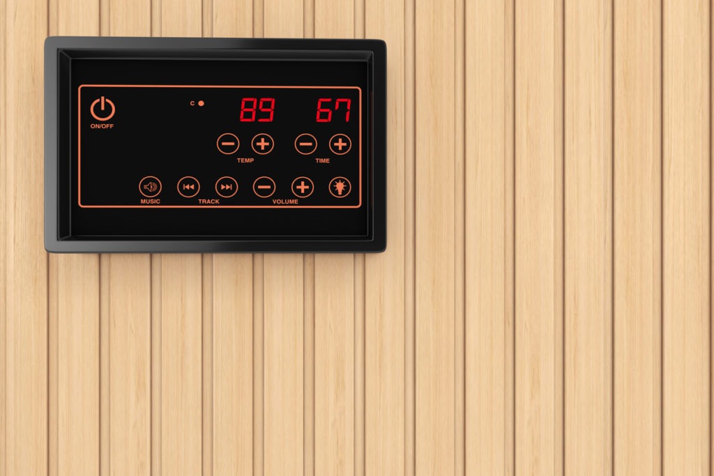 A temperature regulation sensor display on a wooden plank wall background
