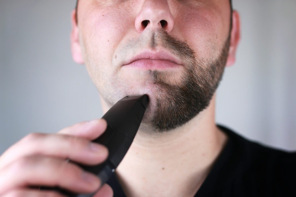 bearded man shaving