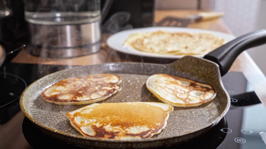 Close-up of mini pancakes on a hot frying pan