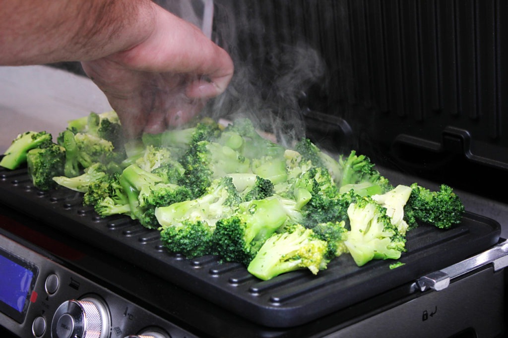 Cooking fresh broccoli on an electric grill
