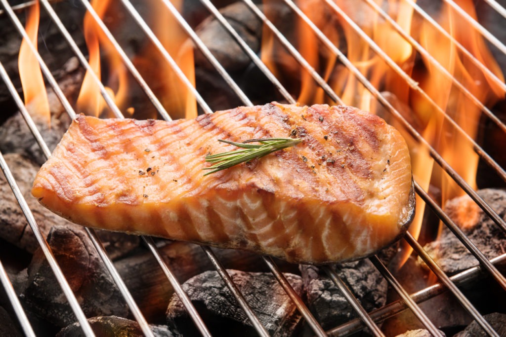 Grilled salmon steak on the flaming