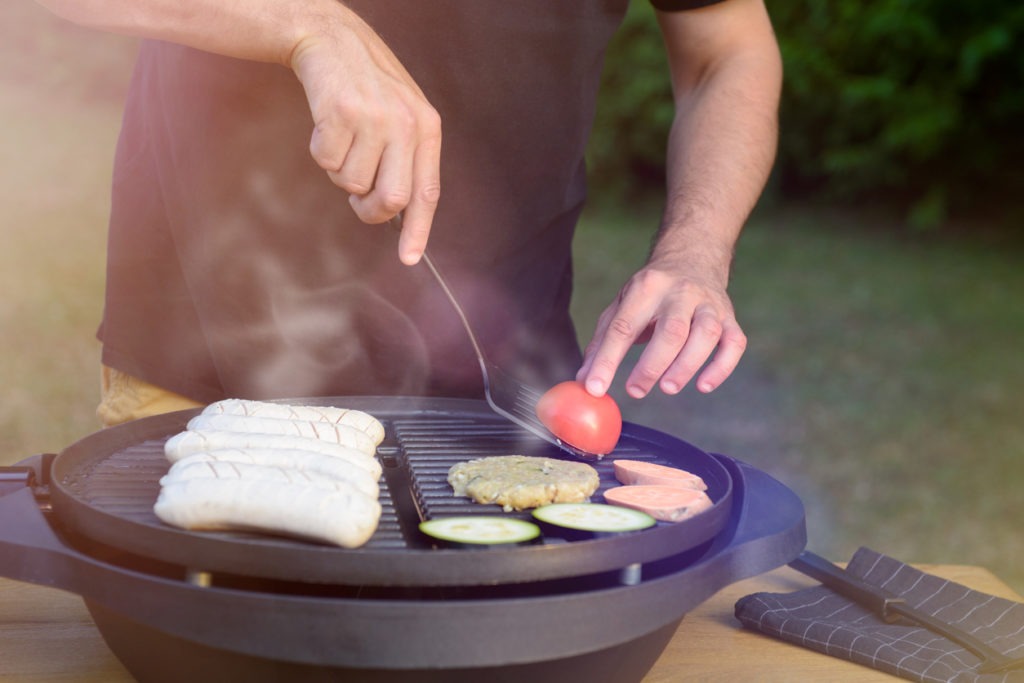 man using electric grill. Garden grill party concept
