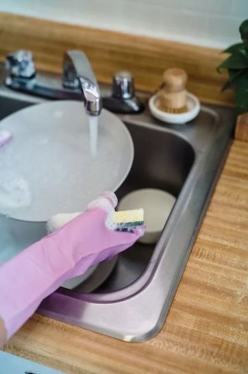 soapy sponge wiping pan