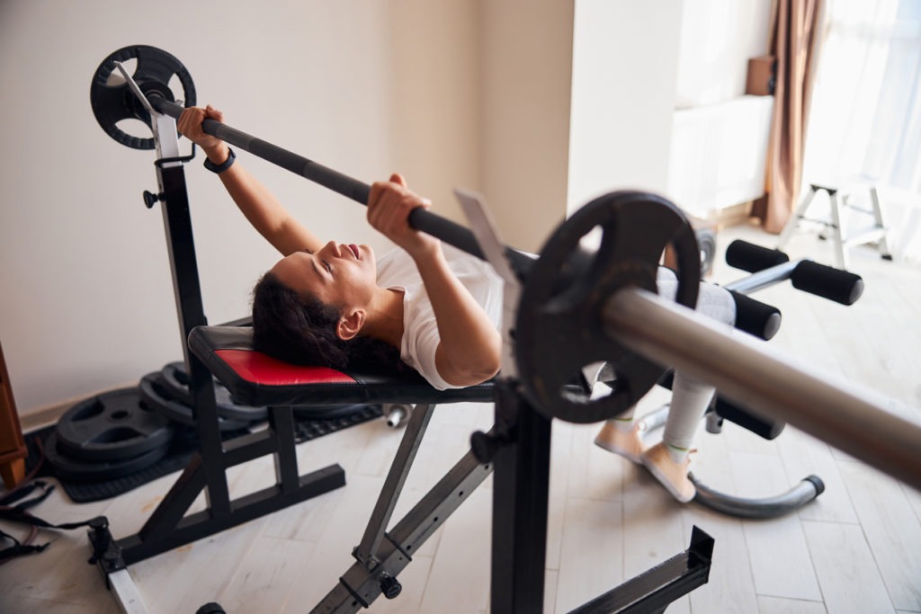 Tranquil athletic woman performing the bench press