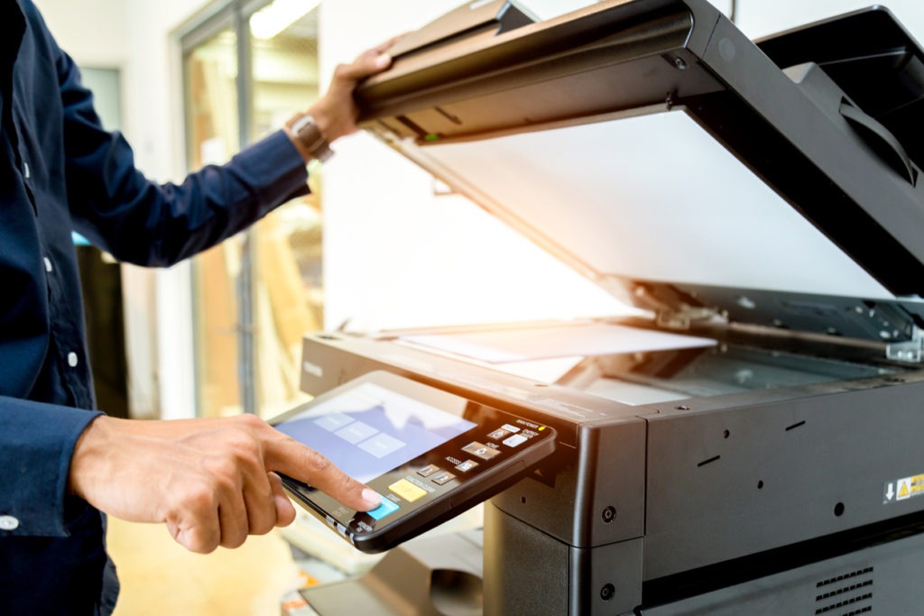 Bussiness man Hand press button on panel of printer, printer scanner laser office copy machine supplies start concept