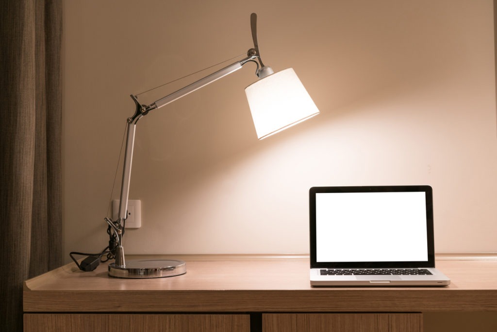 Laptop on a desk with lamp