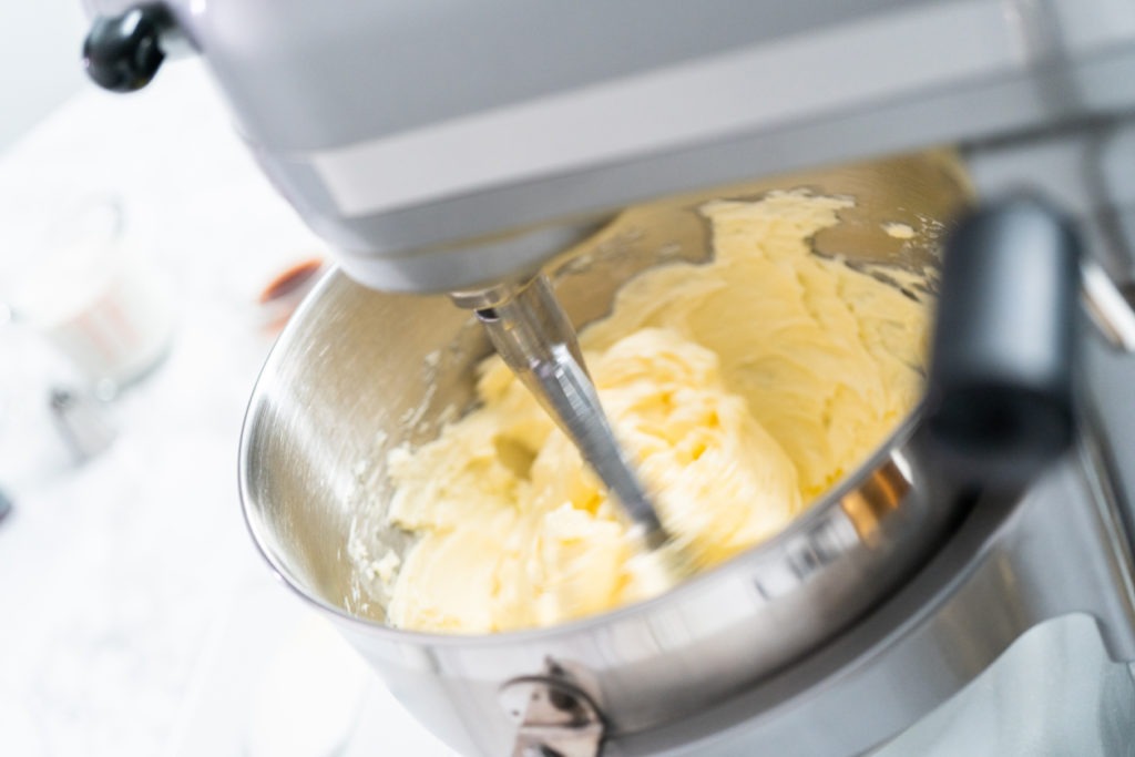 Making buttercream frosting for decorating a vanilla cake