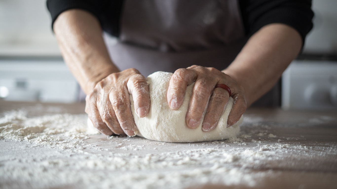 person making pizza dough