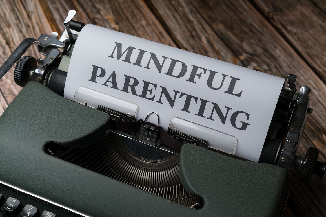 a photo of a black typewriter with mindful parenting print