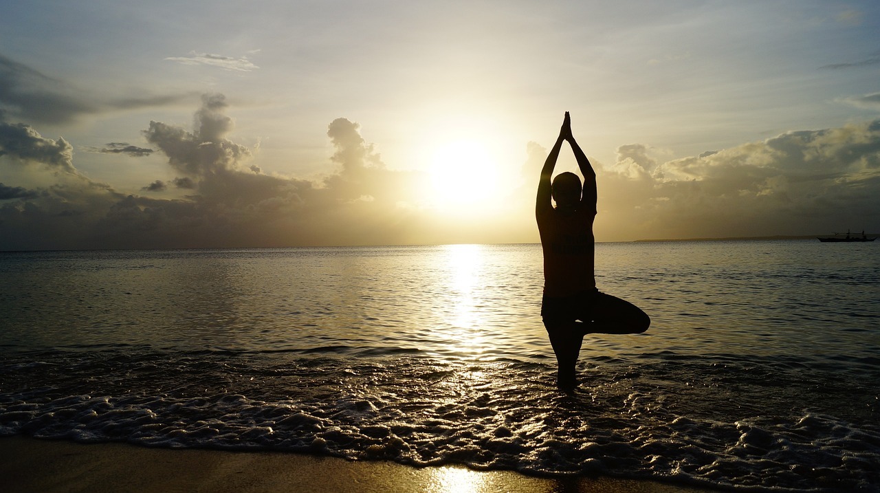 woman doing beach-yoga
